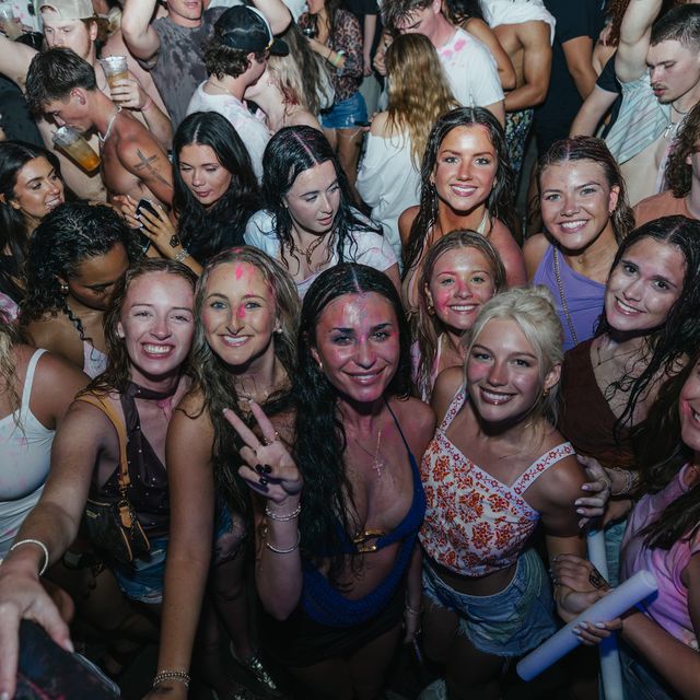 Group of friends posing in the crowd at PCB Spring Break 2026