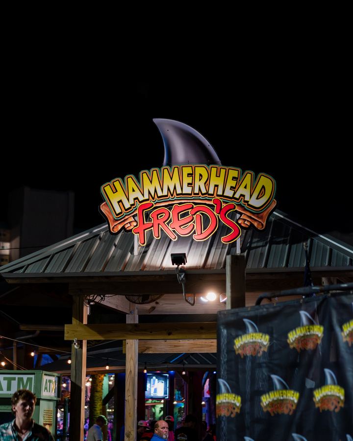 Hammerhead Fred's sign above the entrance at night