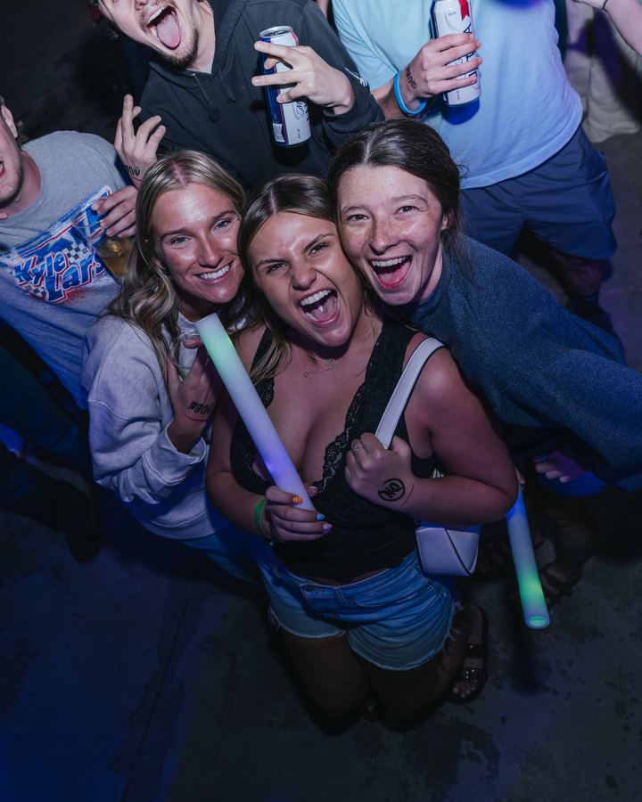 Three friends with a glow stick